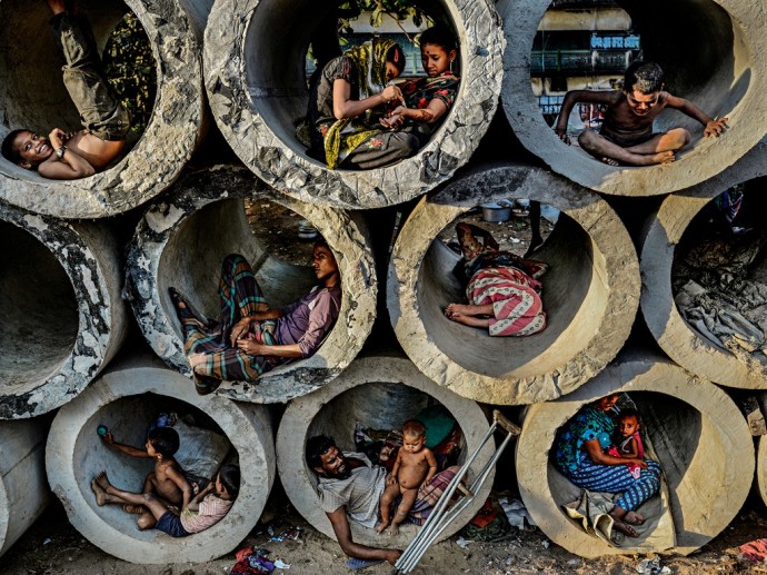 Faisal Azim's image of homeless and destitute people sheltering in drainage pipes in Bangladesh is t