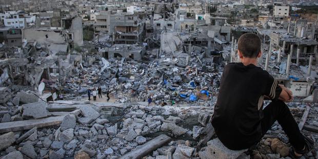 202471_A_Palestinian_child_sits_above_the_ruins_of_his_ruined_home (1)